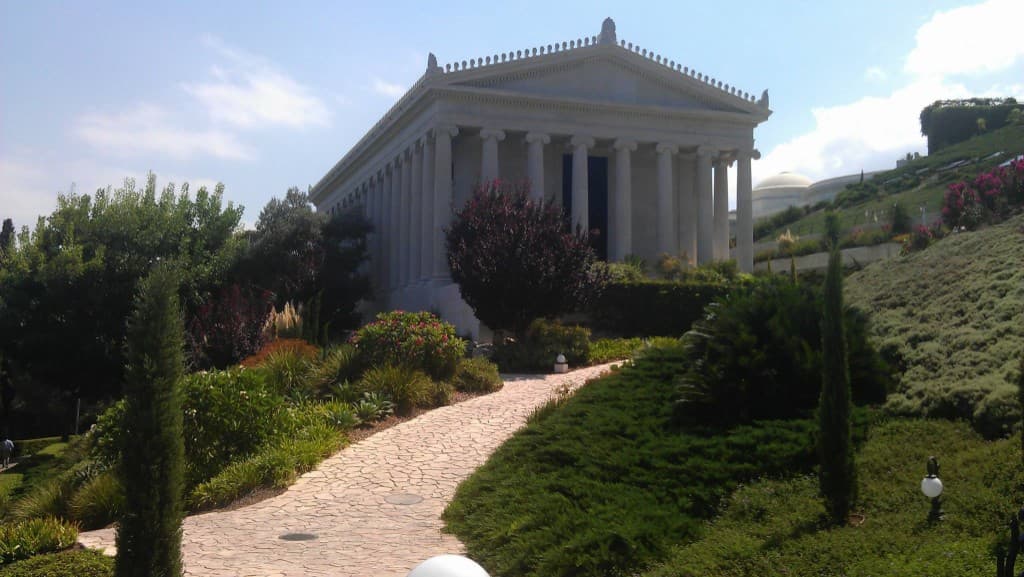 Classical white colonnaded monument amid landscaped gardens in Israel
